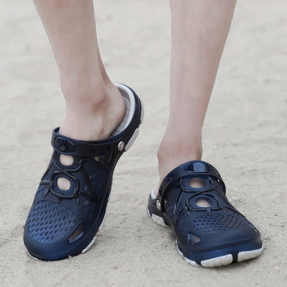 Dark blue clogs with perforated upper, strap detail, and white tread sole