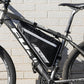 Black front triangle bike bag mounted on mountain bike frame with reflective stripes