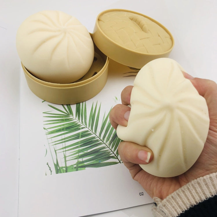 Cream squishy bun toy in hand; two round tan tins with molded bun tops