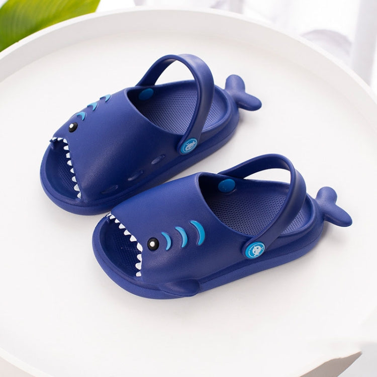 Navy kids shark slippers, pair shown with blue tongue graphic and smile teeth trim