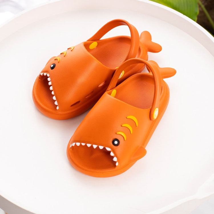 Children's orange shark EVA slippers featuring molded smile and fin accents