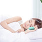 Person sleeping with light blue micro-current sleep aid device on forehead