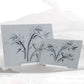 Two gray water writing boards with bamboo-style character practice marks