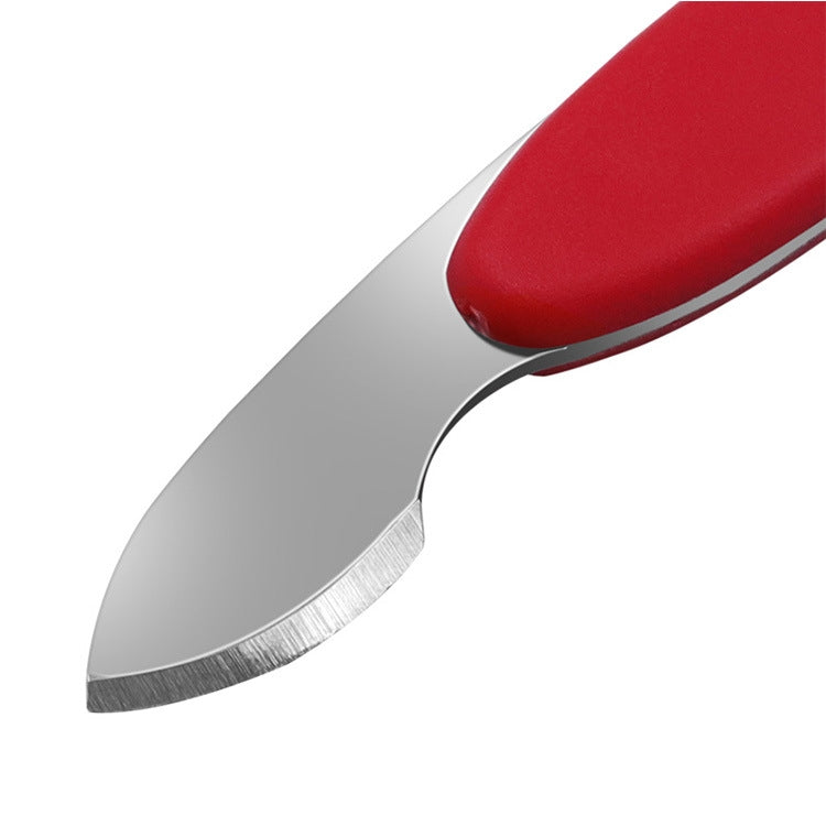 Close-up of red-handled watch repair tool with curved metal blade