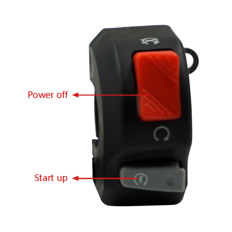 Black motorcycle switch with red rocker and gray control buttons, close-up