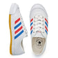 White canvas lace-up track shoes with blue/red stripe; gum-yellow edge outsole visible.