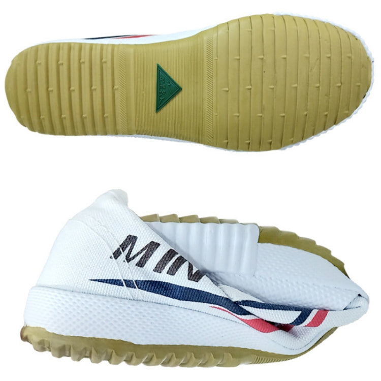 Yellow outsole tread and white shoe heel with blue/red logo on canvas track shoe.