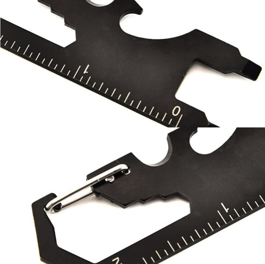 Black multi-tool keychain card close-up of ruler markings and screwdriver blade