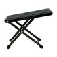 Black folding guitar pedal foot pad with textured tread and cross-leg support
