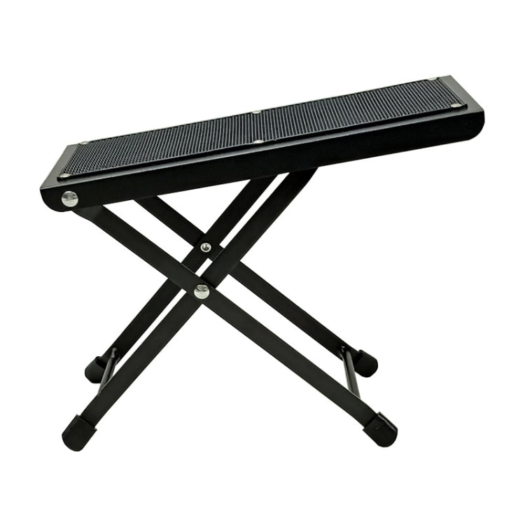 Black folding guitar pedal foot pad with textured tread and cross-leg support