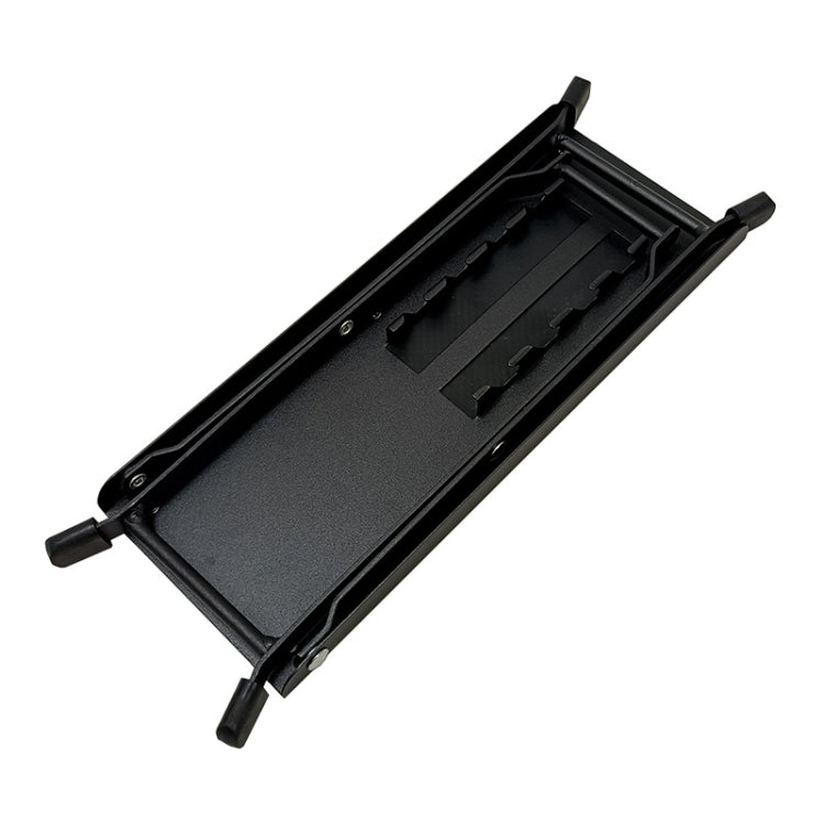 Folded black guitar pedal foot pad with textured surface and storage-ready frame