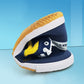 Close-up of blue and white canvas sneaker sole with tread pattern and yellow underside