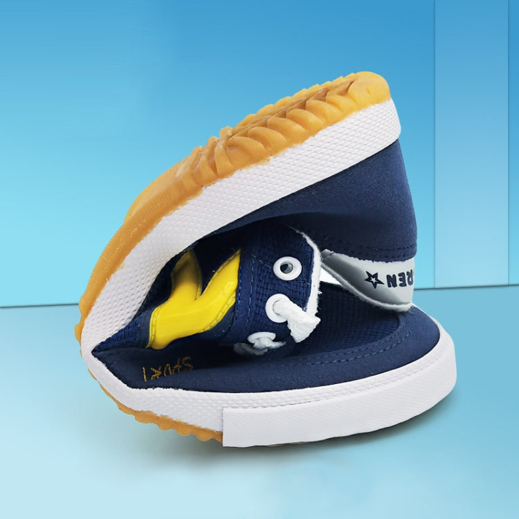 Close-up of blue and white canvas sneaker sole with tread pattern and yellow underside