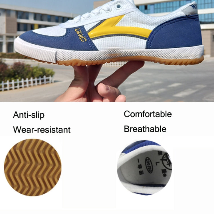 Blue and yellow canvas sneakers with white laces and textured gum outsole, side view