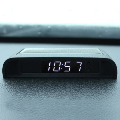 Car digital clock display on black housing, showing 18:57