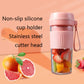 Pink mini juicer cup with fruit pieces and non-slip silicone base detail