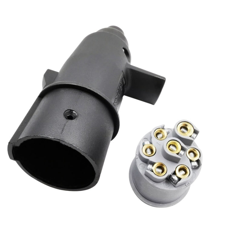 Trailer connector plug with exposed 7-pin contact pins on white base