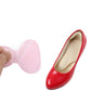 Pink stick-on heel pad beside a red high-heel shoe, half-size cushioning
