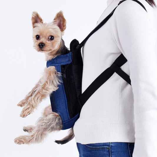 Dog wearing blue denim chest backpack carrier with black cross-body strap