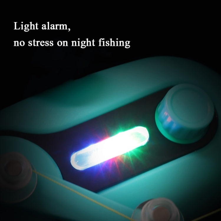 Turquoise bite alarm with bright LED light flash near the fishing rod