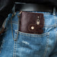 Brown leather wallet worn on jeans with chain strap and front snap tab