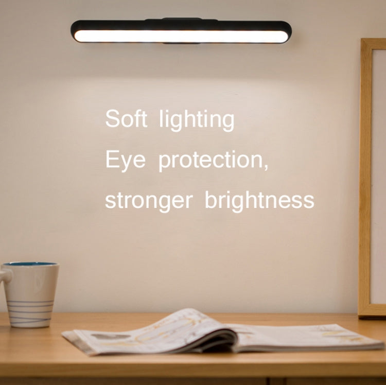 Black LED light bar glowing softly above a desk surface
