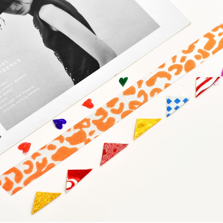 Glitter tape pieces and strips on paper, orange animal print and colorful shapes