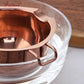 Rose gold stainless steel melting bowl close-up with side loop handle grips