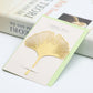 Metal hollow bookmark shaped like a gold ginkgo leaf