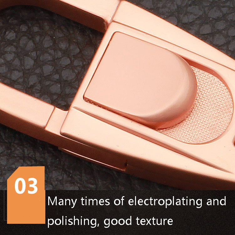 Close-up of rose-gold keychain textured button and double-ring buckle area