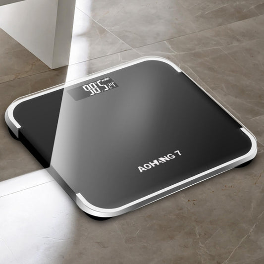 Bright black battery precision digital bathroom scale with LCD display and rounded platform.