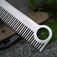 Stainless steel comb with fine teeth and round hole, shown on a textured surface