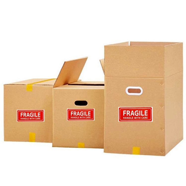 Fragile handle with care warning stickers on brown cardboard shipping boxes