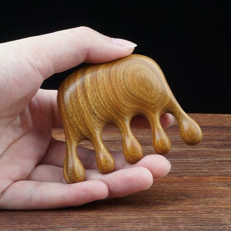Elephant-shaped wooden massage comb held in hand, curved prongs, 8x6cm