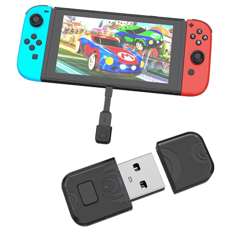 Bluetooth audio transmitter USB adapter connected to handheld gaming console with cable