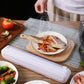 Cling film cutter box dispensing plastic wrap over a cutting board