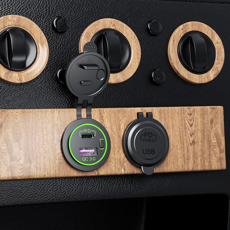 Black car USB charger attached to a surface, showing green QC 3.0 ring