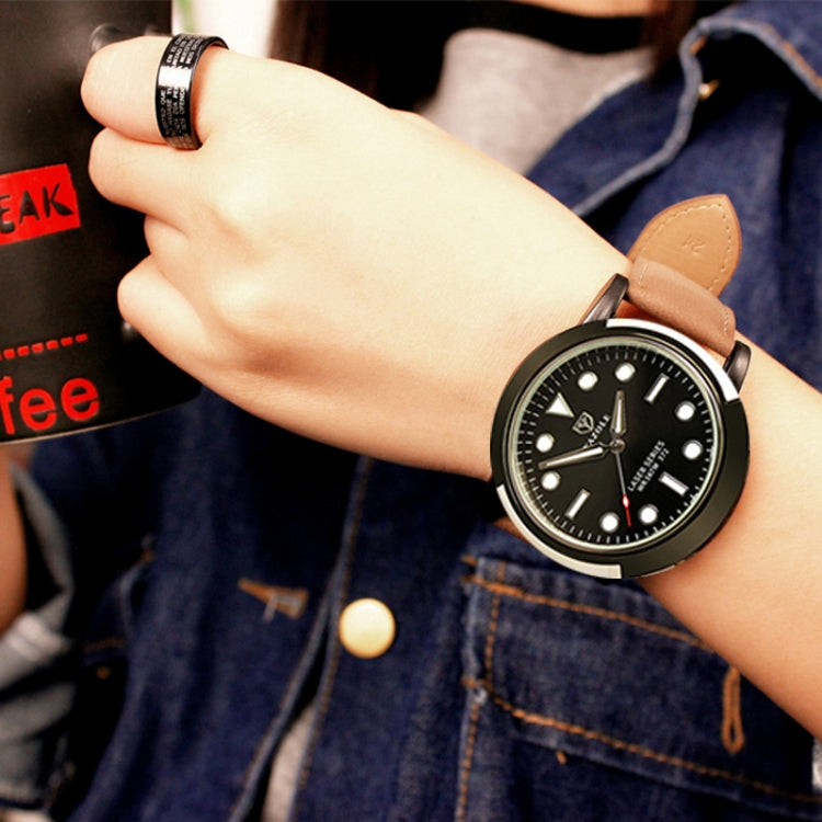 Men's sports watch on wrist with black dial and brown leather strap, silver case