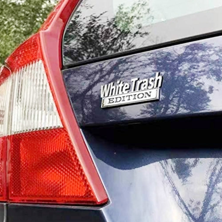 White Trash Edition sticker on a car window near the rear tail light
