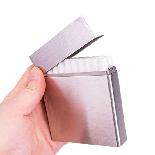 Brushed silver stainless steel clamshell cigarette case, open with white insert and lid.