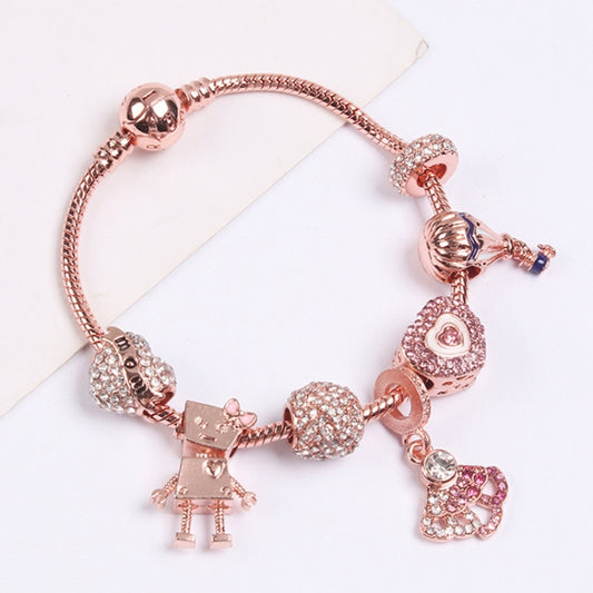 Rose gold beaded charm bracelet with sparkle charms and small dangling heart and figure