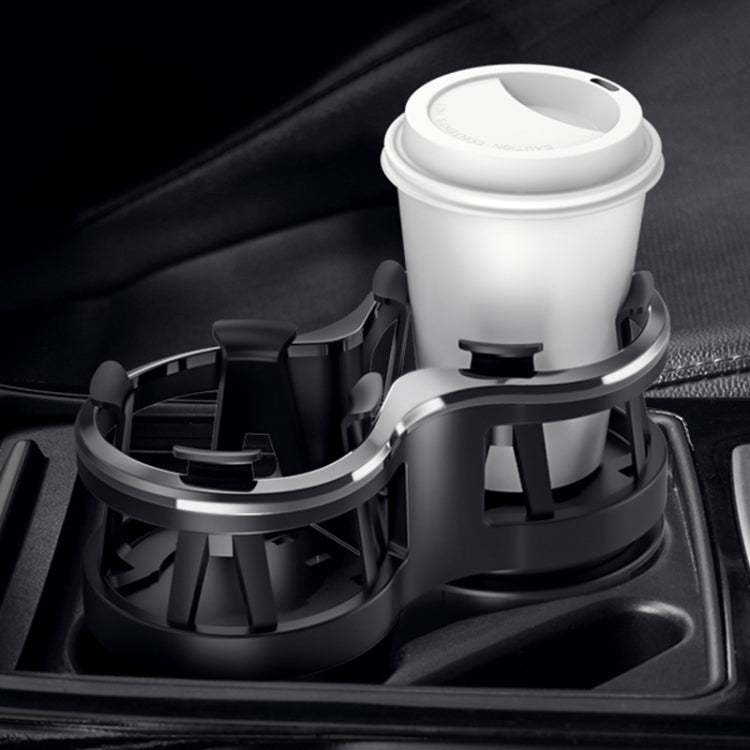 Car dual cup holder holding a white insulated bottle and cup
