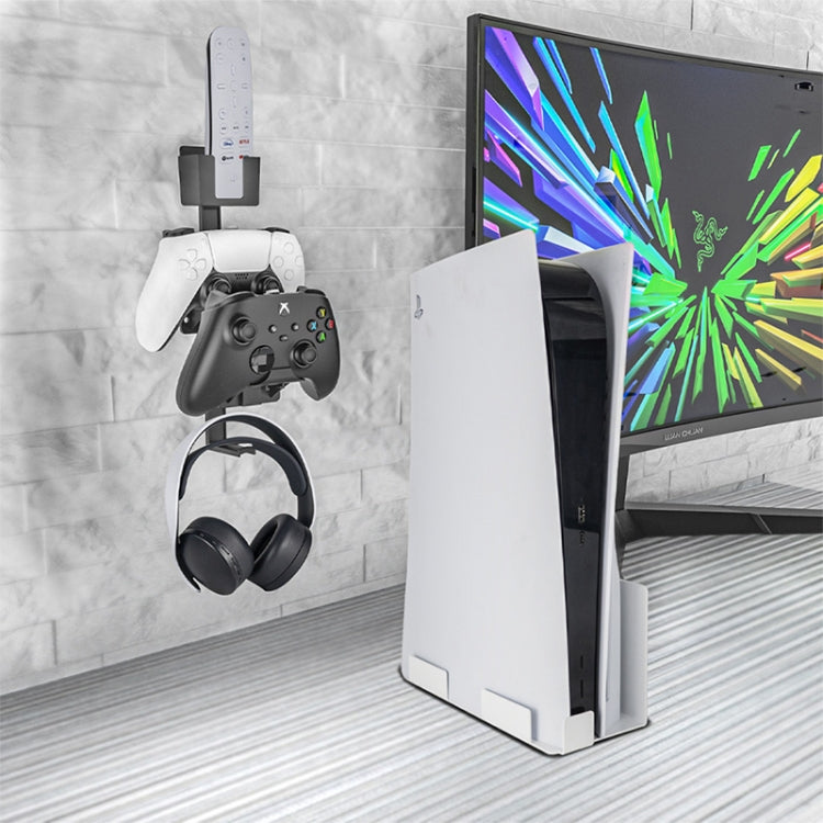 White wall-mounted bracket holding a game controller and wireless headset