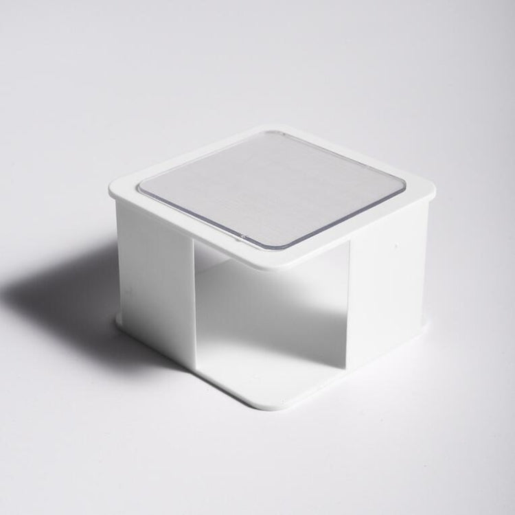 White wall-mounted sponge rack with open front and slotted draining tray
