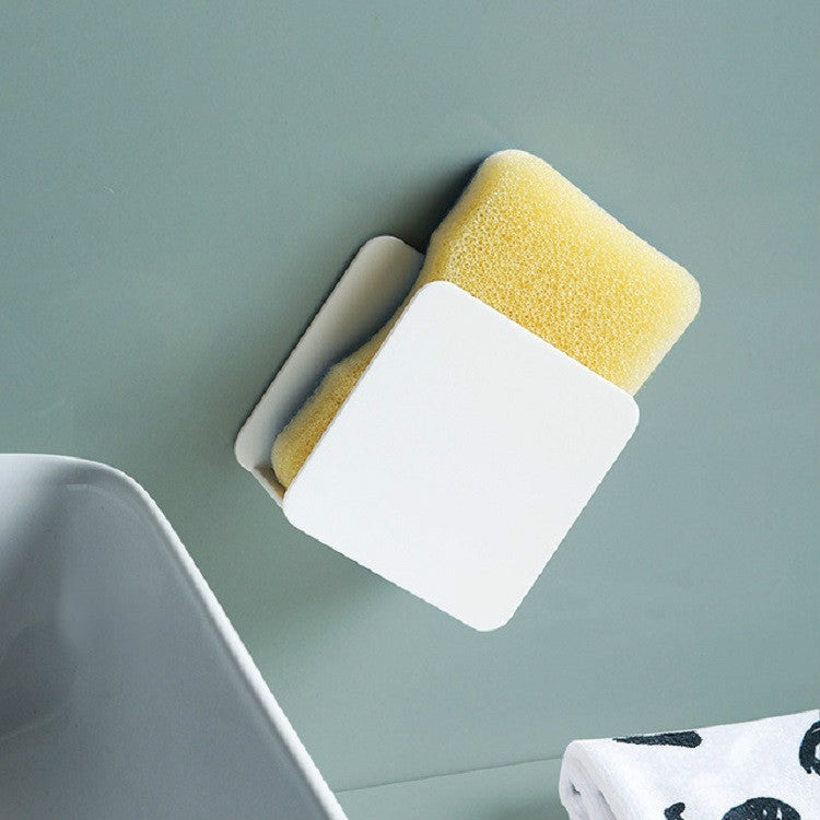 White wall-mounted sponge rack holding a yellow scouring sponge and white pad