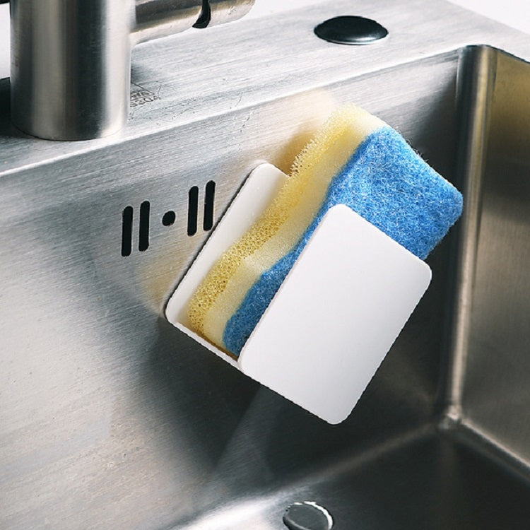 White wall-mounted sponge rack holding yellow and blue sponges on sink