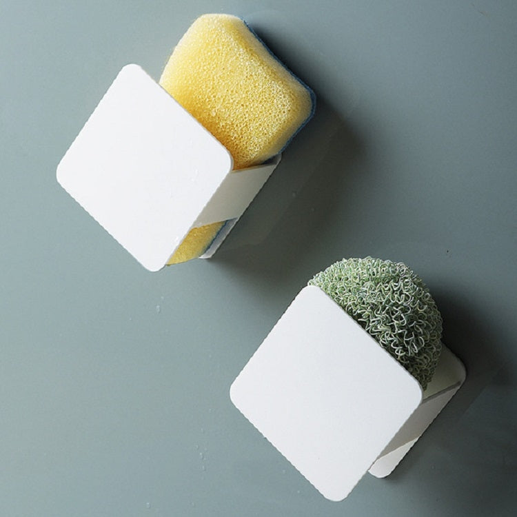 Two white wall-mounted sponge racks with yellow sponge and green scouring pad