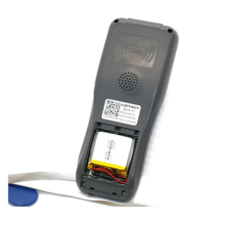 Gray handheld card duplicator with back panel open, showing internal battery and wires
