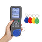Handheld card duplicator in hand with blue, red, yellow, and green key fobs