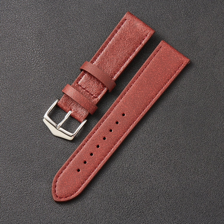 Red leather watch strap with silver buckle, stitched edges and perforation holes